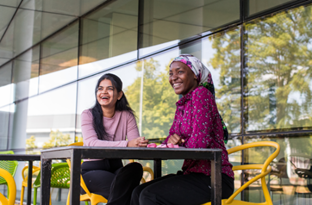 Two women sitting at a table

AI-generated content may be incorrect.