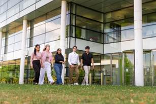 A group of people walking outside a building

AI-generated content may be incorrect.